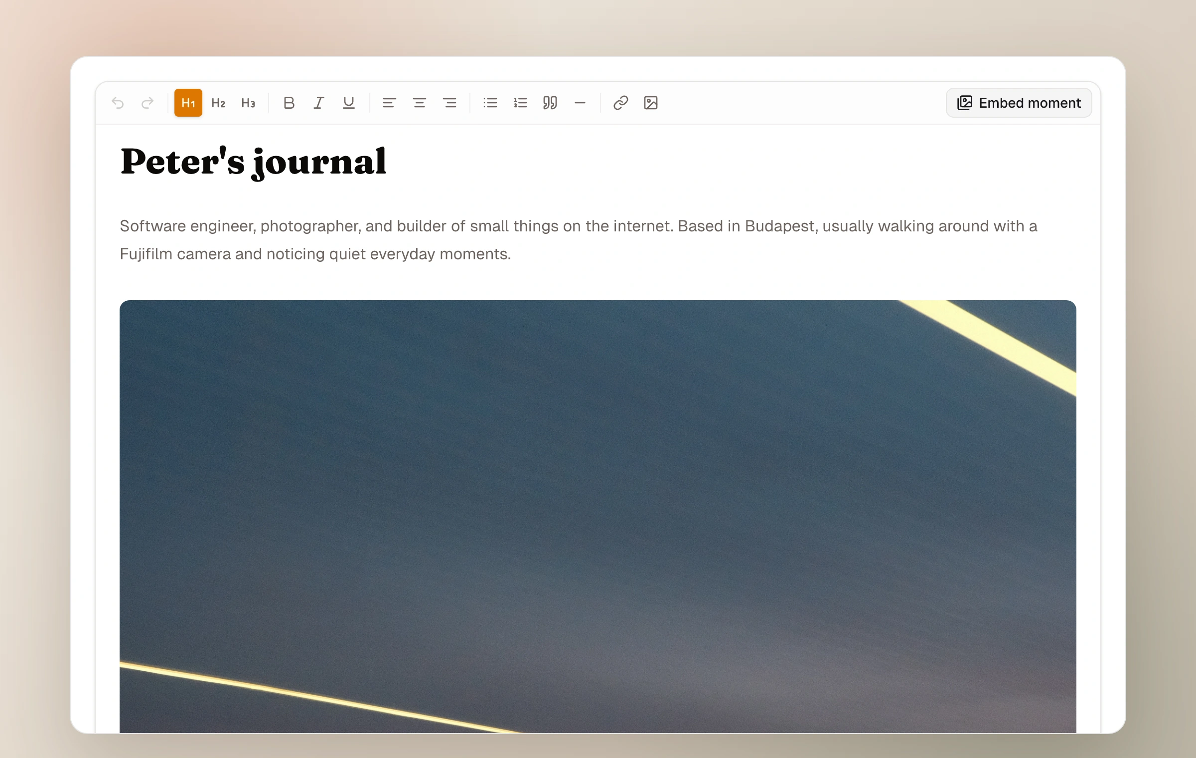 The Moments page editor showing the Embed moment control and an inserted moment card